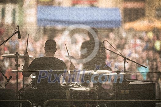 Band performing live on a stage, in front of huge crowd Band performing live on a stage, in front of huge crowd