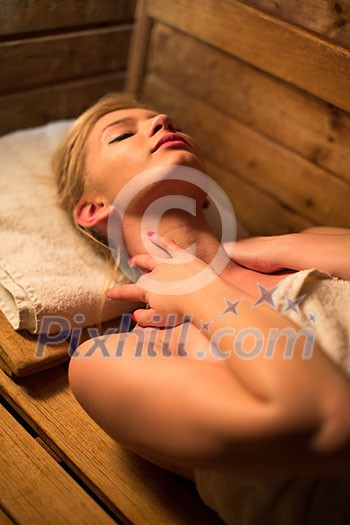 Young woman relaxing in a sauna, taking a break from her busy schedule, taking care of herself, enjoying the wellness benefits her job provides Young woman relaxing in a sauna, taking a break from her busy schedule, taking care of herself, enjoying the wellness benefits her job provides