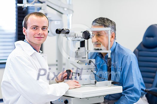 Optometry concept - pretty young woman having her eyes examined by an eye doctor Optometry concept - pretty young woman having her eyes examined by an eye doctor