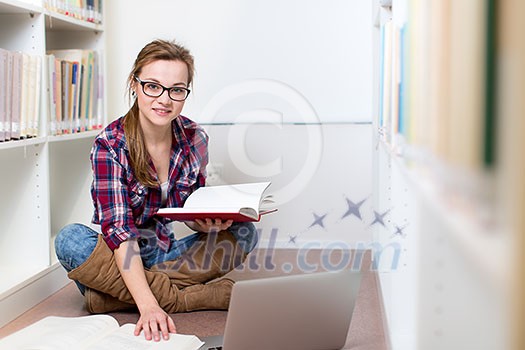 Pretty, female college student in a library, looking for a book (shallow DOF; color toned image) Pretty, female college student in a library, looking for a book (shallow DOF; color toned image)