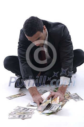 Portrait of a business man holding and catch falling money bills, isolated on white background in studio Portrait of a business man holding and catch falling money bills, isolated on white background in studio