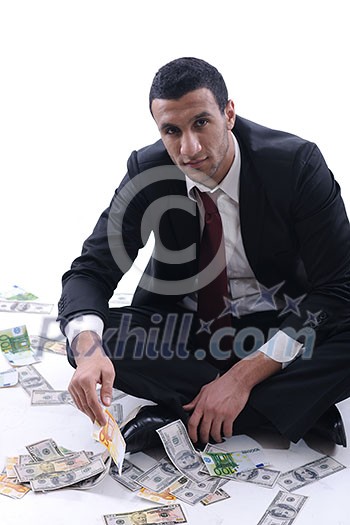 Portrait of a business man holding and catch falling money bills, isolated on white background in studio Portrait of a business man holding and catch falling money bills, isolated on white background in studio