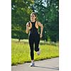 Young beautiful  woman jogging on morning at  park. Woman in sport outdoors health concept