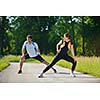 young health couple doing stretching exercise relaxing and warm up after jogging and running in park