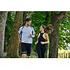 Young couple jogging in park at morning. Health and fitness concept