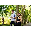 Young couple jogging in park at morning. Health and fitness.