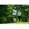 Young couple jogging in park at morning. Health and fitness.