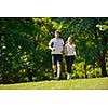 Young couple jogging in park at morning. Health and fitness.