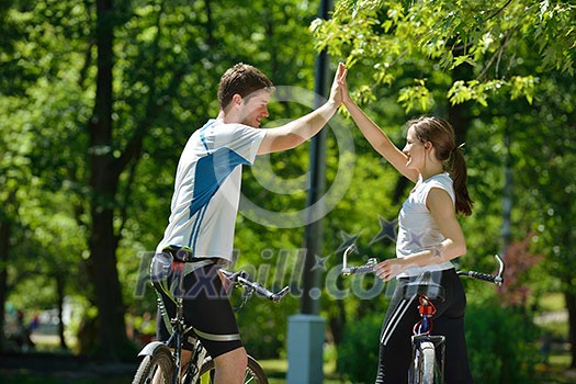 Happy couple ride bicycle outdoors, health lifestyle fun love romance concept Happy couple ride bicycle outdoors, health lifestyle fun love romance concept