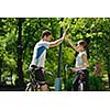 Happy couple ride bicycle outdoors, health lifestyle fun love romance concept