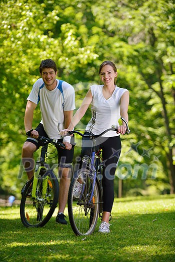 Happy couple ride bicycle outdoors, health lifestyle fun love romance concept Happy couple ride bicycle outdoors, health lifestyle fun love romance concept