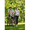 Happy couple ride bicycle outdoors, health lifestyle fun love romance concept