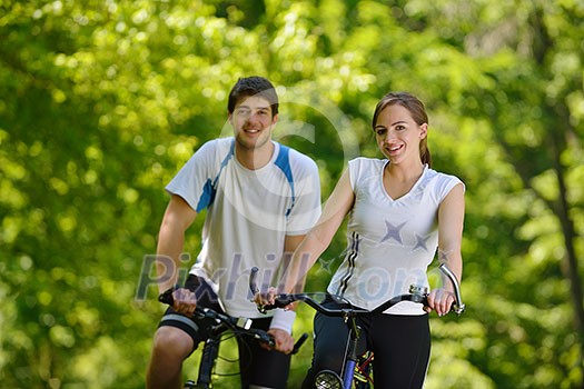 Happy couple ride bicycle outdoors, health lifestyle fun love romance concept Happy couple ride bicycle outdoors, health lifestyle fun love romance concept