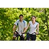 Happy couple ride bicycle outdoors, health lifestyle fun love romance concept