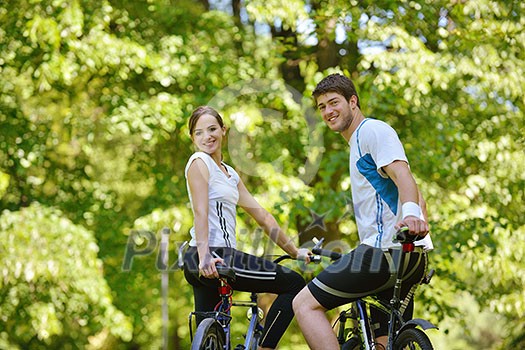 Happy couple ride bicycle outdoors, health lifestyle fun love romance concept Happy couple ride bicycle outdoors, health lifestyle fun love romance concept