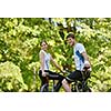 Happy couple ride bicycle outdoors, health lifestyle fun love romance concept