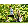 young health couple doing stretching exercise relaxing and warm up after jogging and running in park