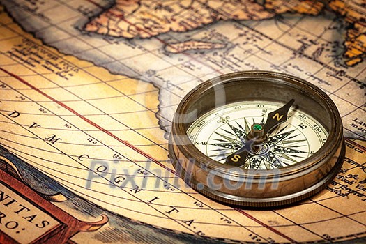 Old vintage retro compass on ancient map Old vintage retro compass on ancient map