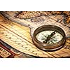 Old vintage retro compass on ancient map