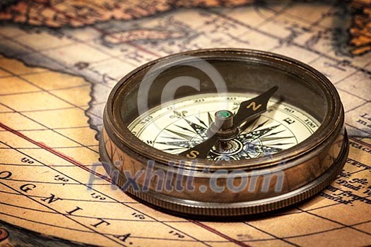 Old vintage retro compass on ancient map Old vintage retro compass on ancient map