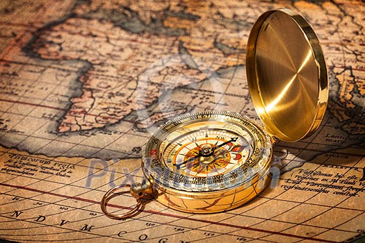 Old vintage retro golden compass on ancient map Old vintage retro golden compass on ancient map