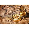 Old vintage retro golden compass on ancient map