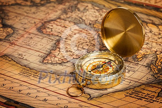 Old vintage retro golden compass on ancient map Old vintage retro golden compass on ancient map