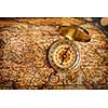 Old vintage retro golden compass on ancient map
