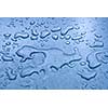 Water droplets on metal background macro blue tinted