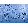 Water droplets on metal background macro blue tinted