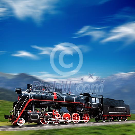 Speeding old locomotive in mountains Speeding old locomotive in mountains