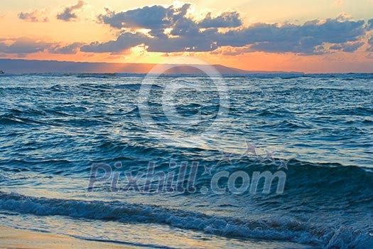 Calm peaceful ocean and beach on tropical sunrise