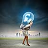 Image of businesswoman holding bulb on back