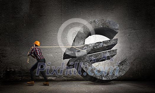 Image of woman engineer pulling euro symbol Image of woman engineer pulling euro symbol