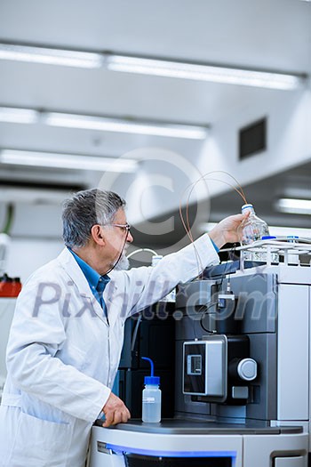 Senior male researcher carrying out scientific research in a lab (shallow DOF; color toned image) Senior male researcher carrying out scientific research in a lab (shallow DOF; color toned image)