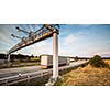 truck passing through a toll gate on a highway (motion blurred image; color toned image)
