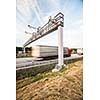 truck passing through a toll gate on a highway (motion blurred image; color toned image)