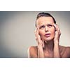 Gorgeous young woman with severe headache/migraine (color toned image)