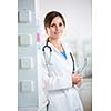 Pretty, female doctor in a hospital lab (image with copy space; color toned)