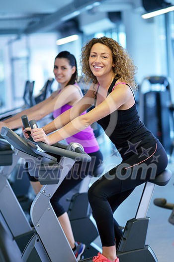group of young people running on treadmills in modern sport gym group of young people running on treadmills in modern sport gym