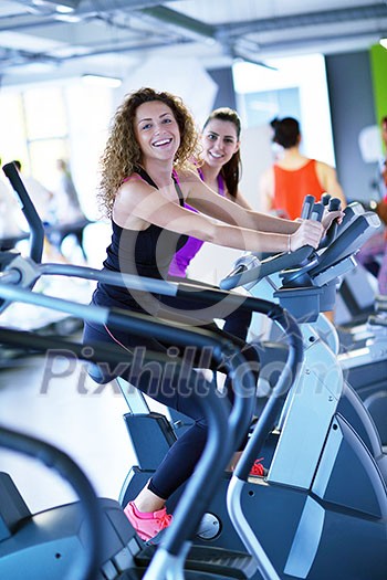 group of young people running on treadmills in modern sport gym group of young people running on treadmills in modern sport gym