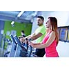 group of young people running on treadmills in modern sport  gym