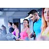 group of young people running on treadmills in modern sport  gym