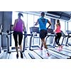 group of young people running on treadmills in modern sport  gym