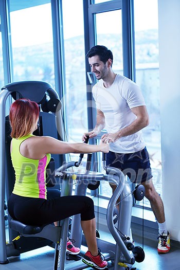Gym woman exercising with her personal trainer Gym woman exercising with her personal trainer