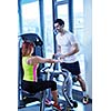 Gym woman exercising with her personal trainer