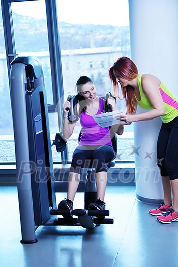 Gym woman exercising with her personal trainer Gym woman exercising with her personal trainer