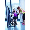 Gym woman exercising with her personal trainer
