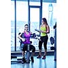 Gym woman exercising with her personal trainer
