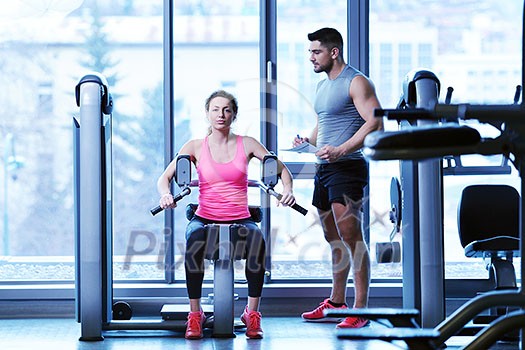 Gym woman exercising with her personal trainer Gym woman exercising with her personal trainer